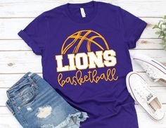 a t - shirt with the word lions basketball printed on it next to ripped jeans