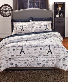 the bed is made up with black and white comforter sets on top of it