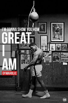 a man walking through a gym holding a barbell in his right hand and the words, i'm going show you how great i am