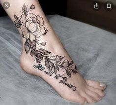 a woman's foot with flowers and words on it