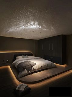 a large bed sitting under a night sky filled with stars