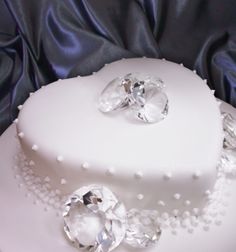 a white wedding cake decorated with crystal jewels