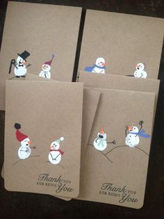 four thank you cards with snowmen and birds on them, all decorated in brown paper