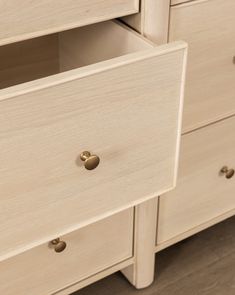 a close up of a dresser with drawers and knobs on the bottom half of it