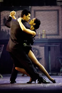 a man and woman dance together on stage