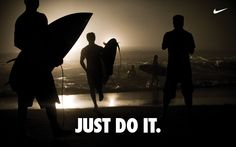 two men holding surfboards standing next to each other with the words just do it