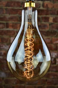 a light bulb hanging from a brick wall with lights in the shape of spirals