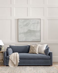 a living room with a blue couch and white walls