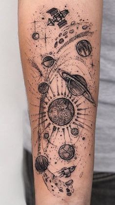 a man's arm with an image of planets and stars on it in black ink