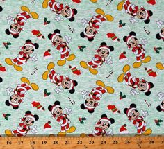 mickey mouse christmas fabric with santa clause on it