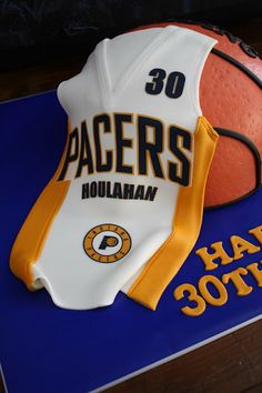 a cake shaped like a basketball and glove with the number 30 on it's side