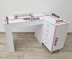 a white desk with measurements for the drawers