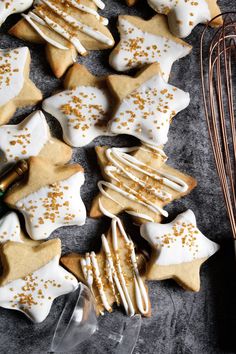 cookies with white icing and gold sprinkles