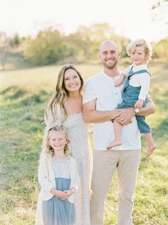 a family posing for a photo in the grass