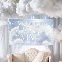 a white couch sitting in front of a cloud filled sky with the words, this bride is on top of it