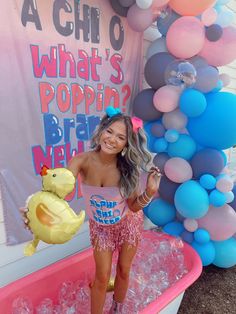 a woman standing in an ice bath with balloons