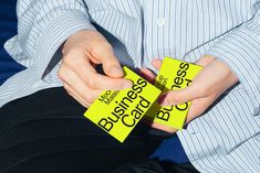 a person holding two yellow business cards in their hands with the word boss written on them