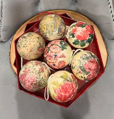 a red bowl filled with lots of decorated eggs