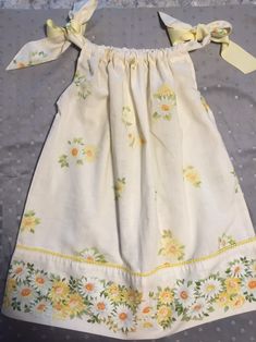 These adorable vintage pillowcase sundresses are simply precious! They fit a variety of sizes due the the ties at the shoulders. Each dress is unique, and you can choose ribbon tie colors and add embellishments such as bows, buttons etc. I'm constantly shopping for vintage pillowcases so the selection will vary. I'll do my best to find Colors and patterns you choose. Cute Sundress With Tie Straps For Garden Party, Cute Cotton Dresses With Tie Straps, Cute Cotton Dress With Tie Straps, Cute Sleeveless Sundress With Tie Back, Cute Cotton Sundress With Spaghetti Straps, Cotton Maxi Sundress With Tie Back, Upcycle Dress, Pillowcase Dress Pattern, Vintage Toddler