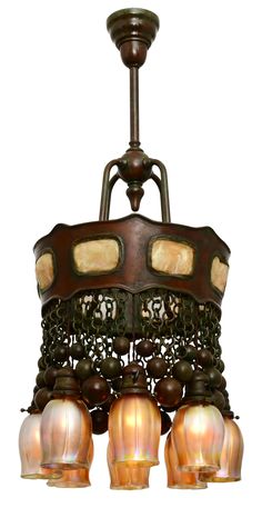 an antique chandelier with five lights hanging from it's center and four shades on the bottom