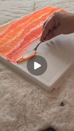 someone is cutting up some fish on a sheet of paper