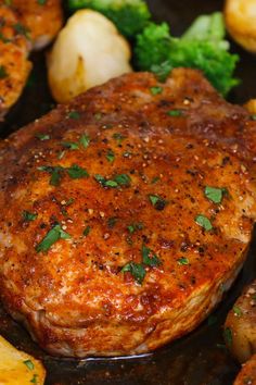 a close up of some meat and potatoes on a pan