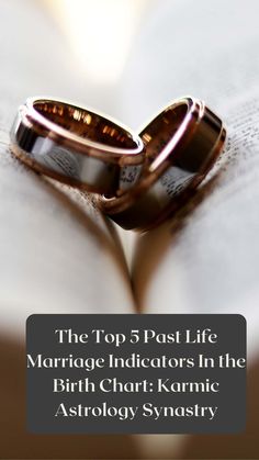 two wedding rings sitting on top of an open book with text overlaying the top 5 past life marriage indicators in the birth