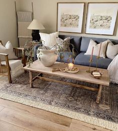 a living room filled with furniture and decor on top of a wooden floor covered in rugs