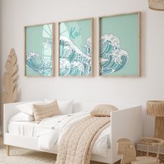 a bedroom with two pictures hanging above the bed