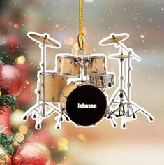 a christmas tree ornament with a drum set hanging from it