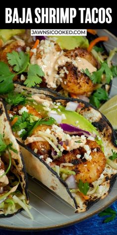 grilled shrimp tacos on a plate with cilantro and avocado