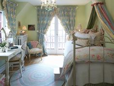 a bed room with a neatly made bed and a chandelier hanging from the ceiling