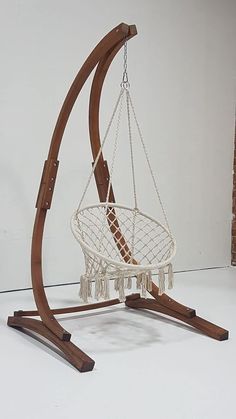 a wooden stand holding a white hanging chair