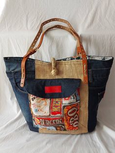 a handbag made out of old jeans and soda cans is displayed on a white background