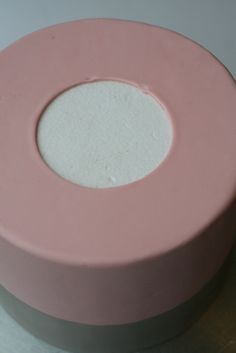 a pink cake with white frosting on top