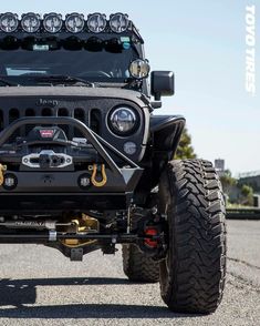 the front end of a black jeep with lights on