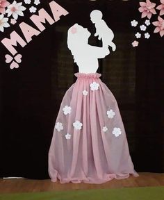 a paper cutout of a woman holding a baby in her arms with the word mama on it