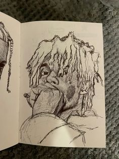 a drawing of a man with dreadlocks on his head is shown in an open book