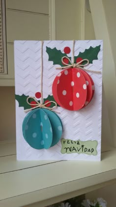 a card with two paper ornaments attached to it