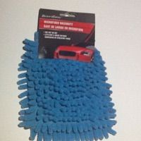 a blue scrub brush with a red car in the background