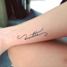 a woman with a tattoo on her arm that says,'little'in cursive writing