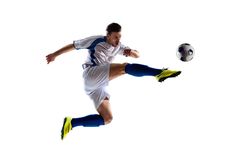 a man kicking a soccer ball in the air