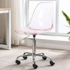 a clear plastic office chair sitting in front of a window with wheels on the floor