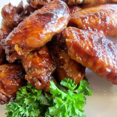 chicken wings with parsley on the side, ready to be eaten by someone else