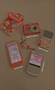 four different cell phones with hello kitty pictures on them, one has a camera and the other has an mp3 player