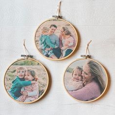 three embroidery hoop hangings with pictures of people and children in them on a white surface