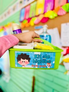 a child's hand holding a plastic container filled with liquid