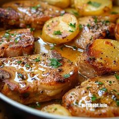 some meat and potatoes are cooking in a pan