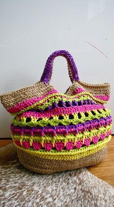 a multicolored basket sitting on top of a wooden floor