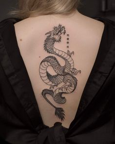 a woman with a dragon tattoo on her back